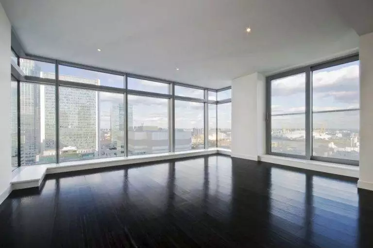 Floor-to-ceiling grey aluminium windows in a modern high-rise apartment with panoramic city views – Cristal Windows, Doors & Conservatories