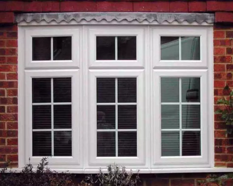 White uPVC casement bay window with Georgian bars on a red brick home - Cristal Windows, Doors & Conservatories