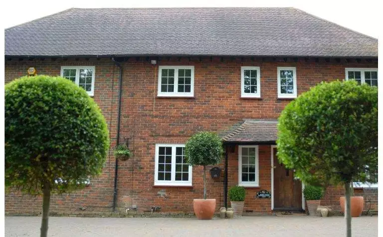 Traditional brick home featuring sleek white aluminium windows for enhanced durability and modern energy efficiency – Cristal Windows, Doors & Conservatories