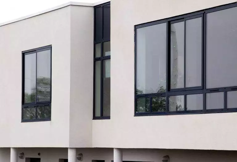 Contemporary building with large black aluminium windows providing a sleek, modern finish – Cristal Windows, Doors & Conservatories
