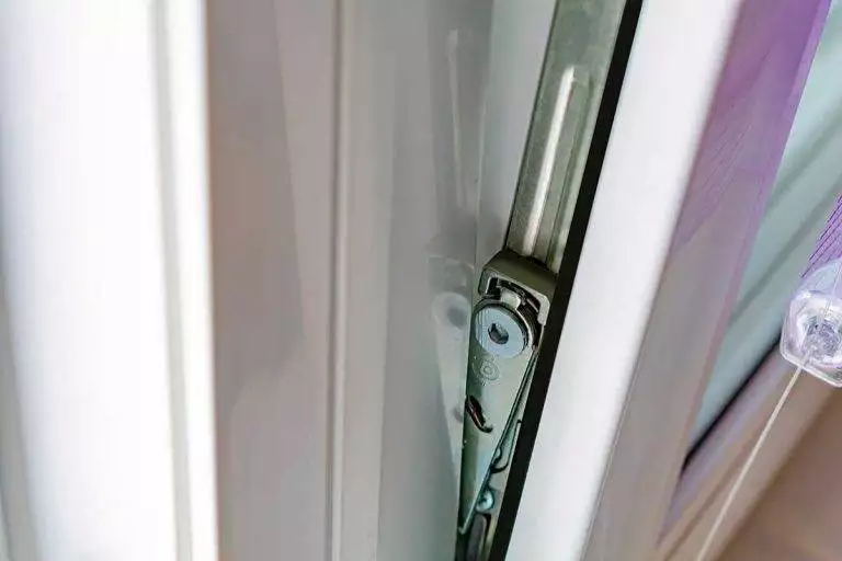 Close-up of tilt and turn window hinge mechanism on a white uPVC frame – Cristal Windows, Doors & Conservatories