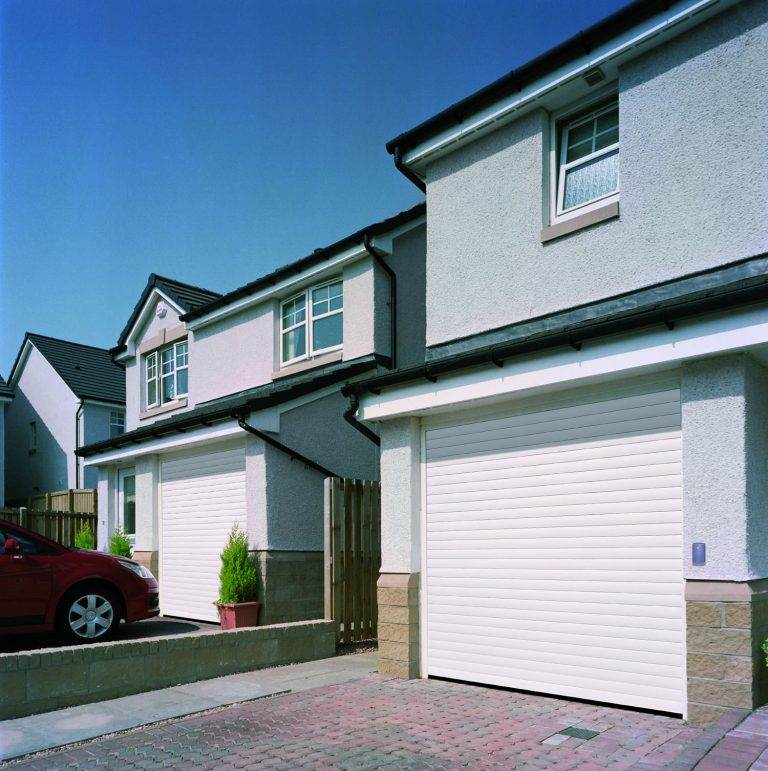 Modern suburban homes with white roller garage doors providing a sleek and secure finish – Cristal Windows, Doors & Conservatories