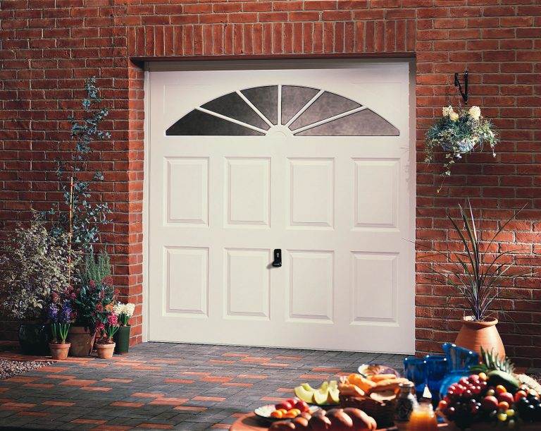 Classic white panelled up and over garage door with decorative arched window design – Cristal Windows, Doors & Conservatories