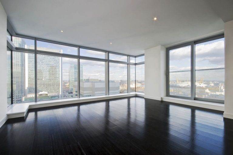 Floor-to-ceiling grey aluminium windows in a modern high-rise apartment with panoramic city views – Cristal Windows, Doors & Conservatories