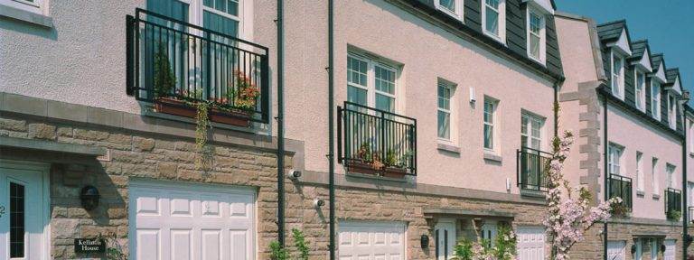 Modern townhouse development with white uPVC casement windows and Juliet balconies - Cristal Windows, Doors & Conservatories