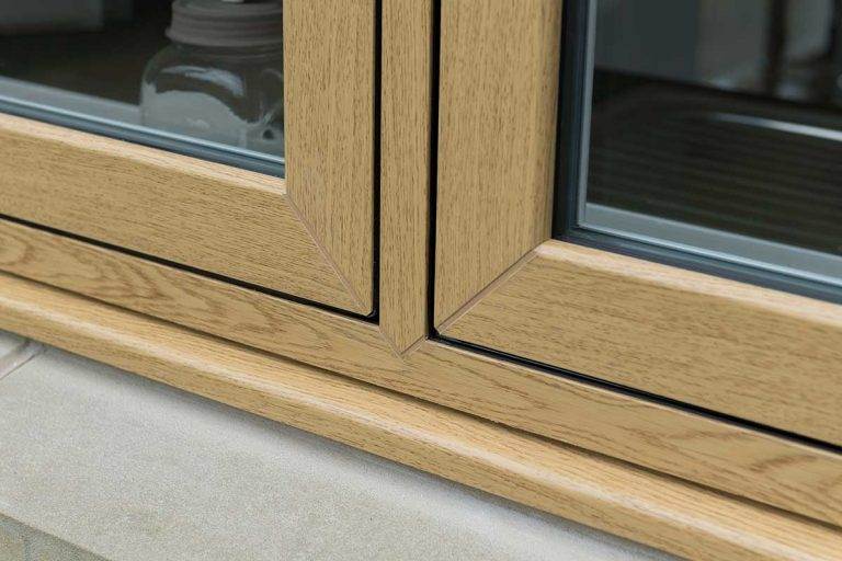 Close-up of oak-effect uPVC flush casement window frame with seamless corner join – Cristal Windows, Doors & Conservatories