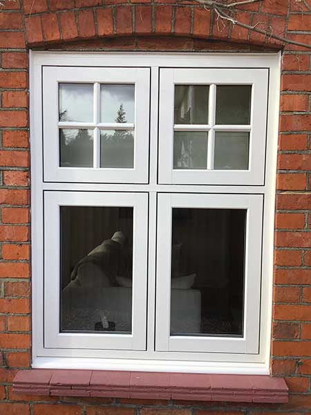 White uPVC flush casement windows with Georgian bar detailing on a red brick exterior – Cristal Windows, Doors & Conservatories