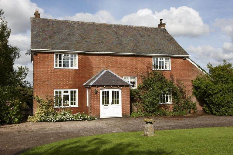 Traditional red brick home with white uPVC double glazed windows and doors - Cristal Windows, Doors & Conservatories