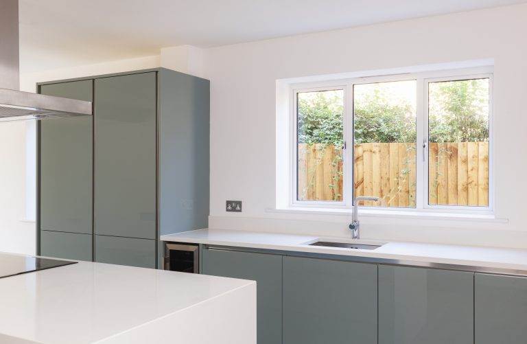 Modern white aluminium kitchen window with slim frames above a minimalist sink – Cristal Windows, Doors & Conservatories