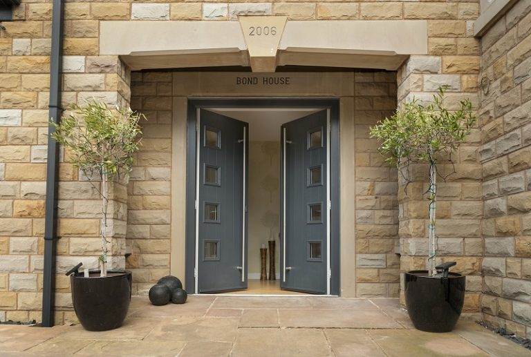 Modern grey composite double front doors with square glazed panels set in stone entrance – Cristal Windows, Doors & Conservatories