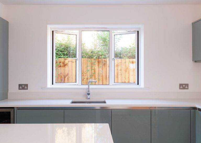 Sleek aluminium kitchen window with two side openers and a central fixed panel, offering modern ventilation and clean lines – Cristal Windows, Doors & Conservatories