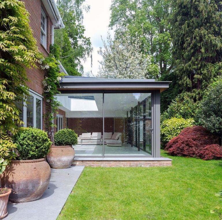 Exterior view of modern extension with floor-to-ceiling aluminium patio doors opening to garden – Cristal Windows, Doors & Conservatories