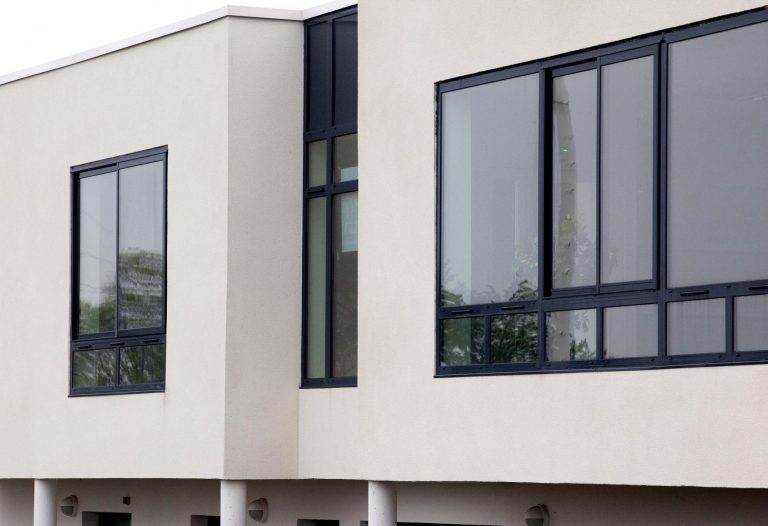 Contemporary building with large black aluminium windows providing a sleek, modern finish – Cristal Windows, Doors & Conservatories