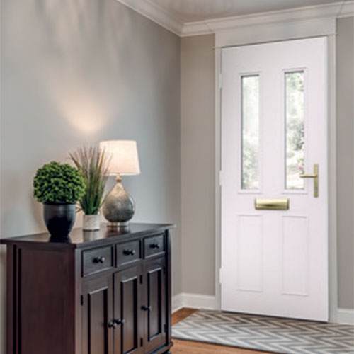 Interior view of white aluminium composite front door with vertical glazed panels and gold hardware – Cristal Windows, Doors & Conservatories