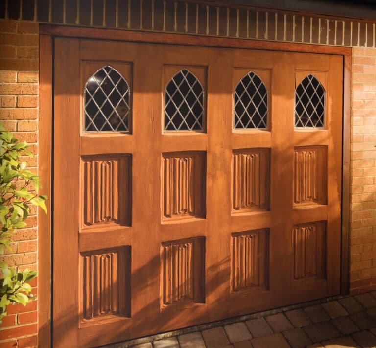 Traditional wooden garage door with decorative panels and diamond leaded glass windows, adding character and charm to the home – Cristal Windows, Doors & Conservatories