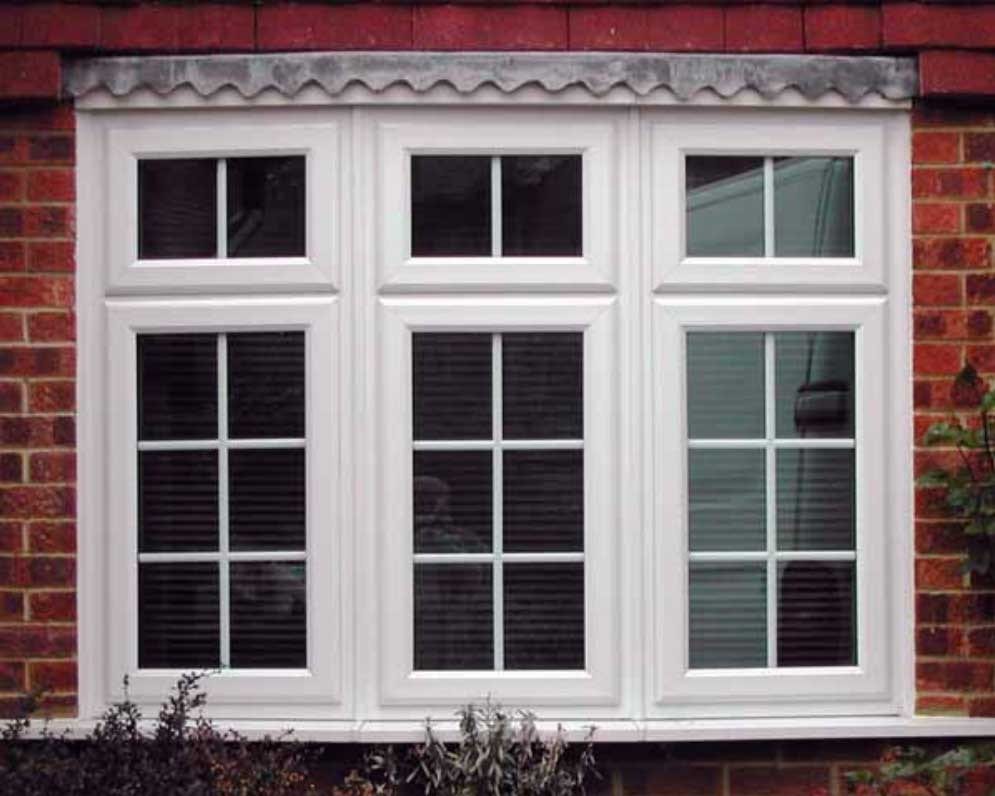 White uPVC casement bay window with Georgian bars on a red brick home - Cristal Windows, Doors & Conservatories