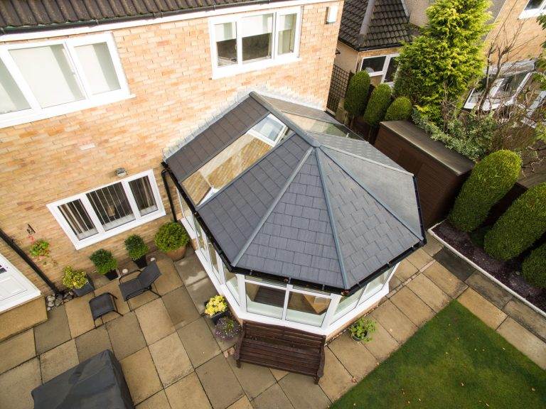 Conservatory roof replacement with modern tiled roof and skylight, improving insulation and style – Cristal Windows, Doors & Conservatories