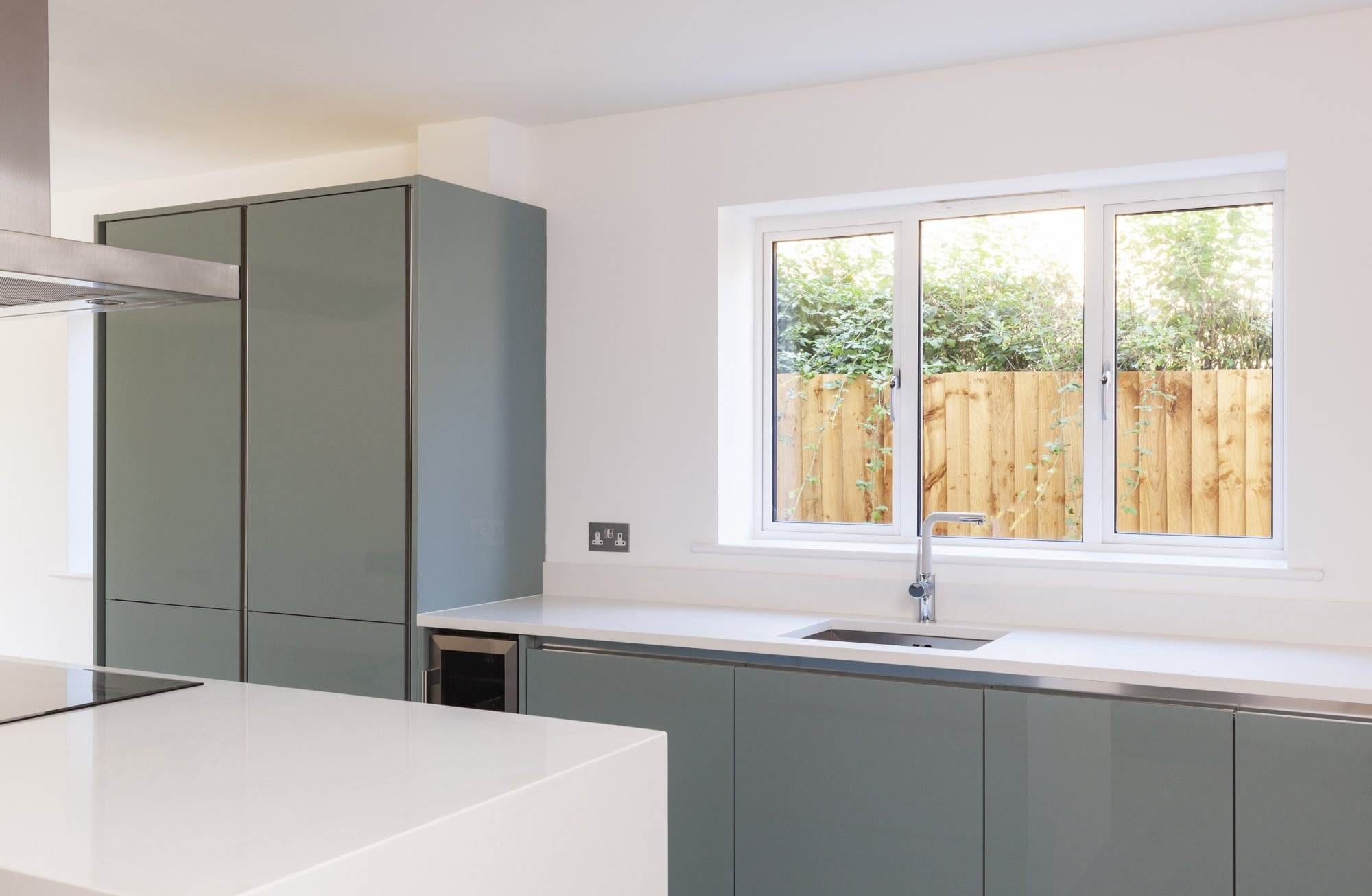 Modern white aluminium kitchen window with slim frames above a minimalist sink – Cristal Windows, Doors & Conservatories