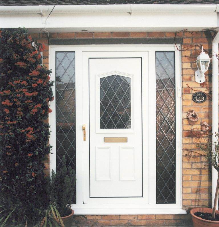 White uPVC residential front door with diamond-patterned leaded glass panels and gold handle – Cristal Windows, Doors & Conservatories